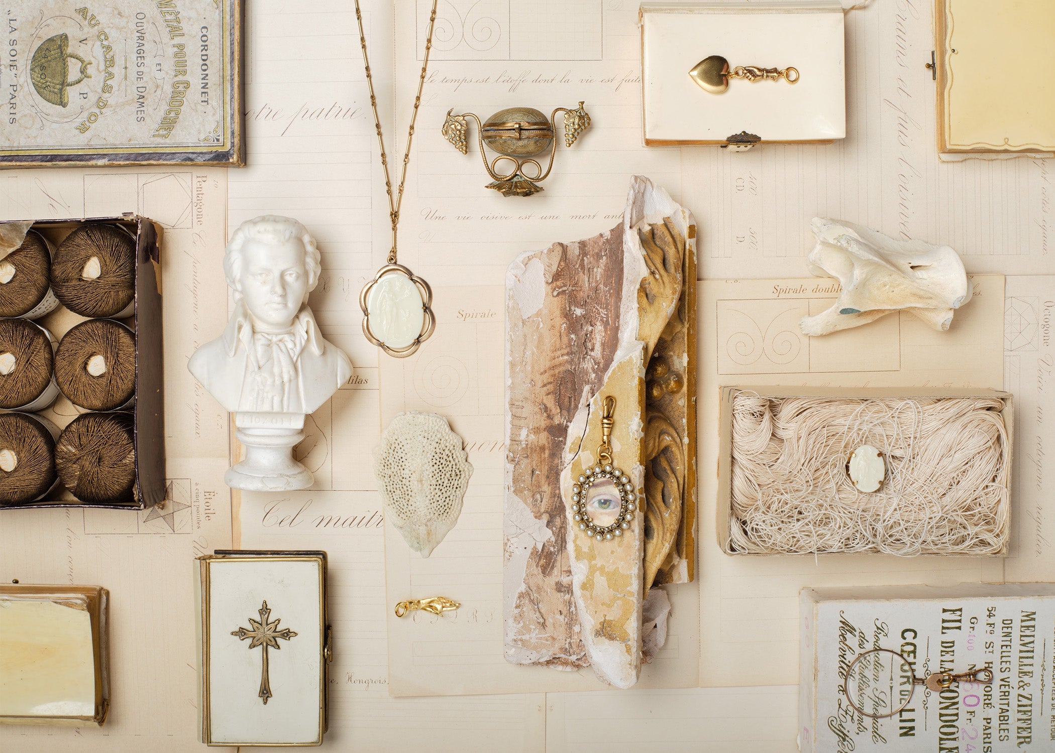 Ivory Flatlay of fallen aristocrat jewlery mixed with antiques 